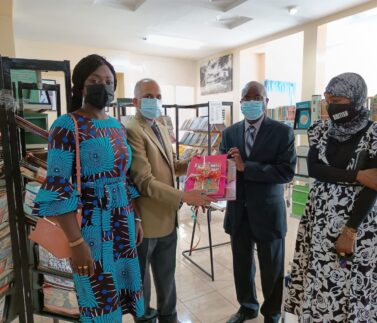 Ambassador handing over a symbolical gift of books at inauguration event